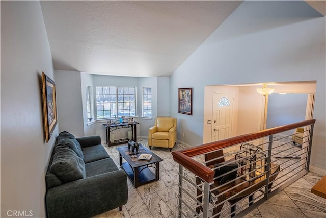 living area with lofted ceiling and baseboards