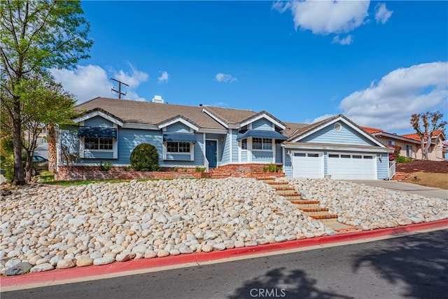 ranch-style house with driveway and an attached garage