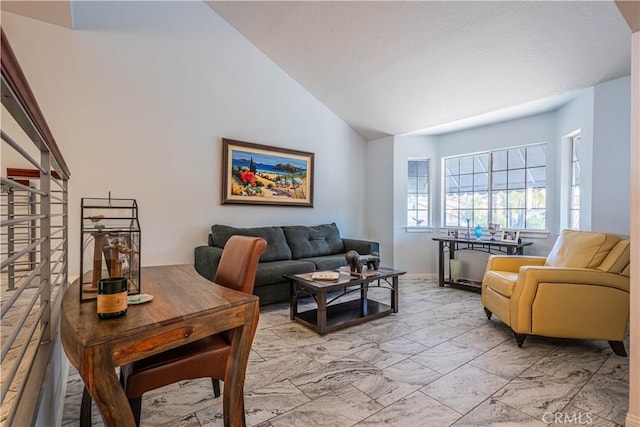 living area featuring marble finish floor and high vaulted ceiling