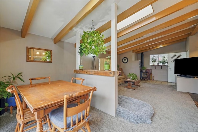 30919 Valley Oak Dr, Running Springs, CA 92382 - carpeted dining space featuring beamed ceiling and a wood stove