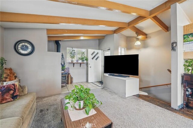 30919 Valley Oak Dr, Running Springs, CA 92382 - carpeted living area with a wood stove, beamed ceiling, and plenty of natural light