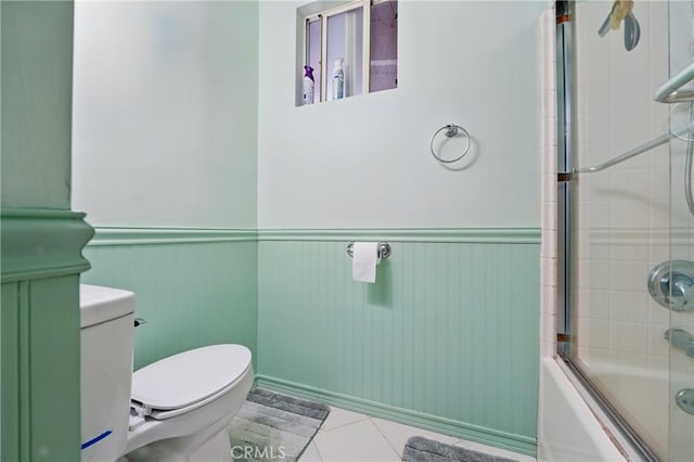 30919 Valley Oak Dr, Running Springs, CA 92382 - bathroom featuring wainscoting, tile patterned floors, and shower / bath combination with glass door