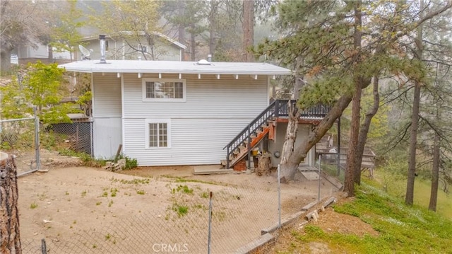 30919 Valley Oak Dr, Running Springs, CA 92382 - rear view of house with stairway and a wooden deck