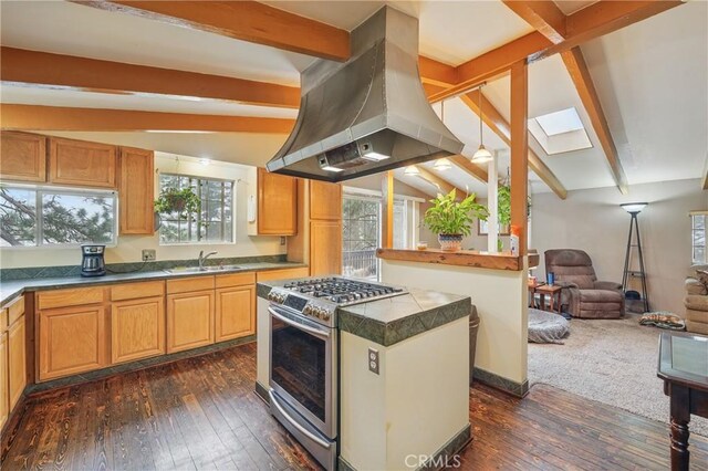 30919 Valley Oak Dr, Running Springs, CA 92382 - kitchen featuring stainless steel range with gas stovetop, island exhaust hood, a skylight, open floor plan, and dark wood-type flooring