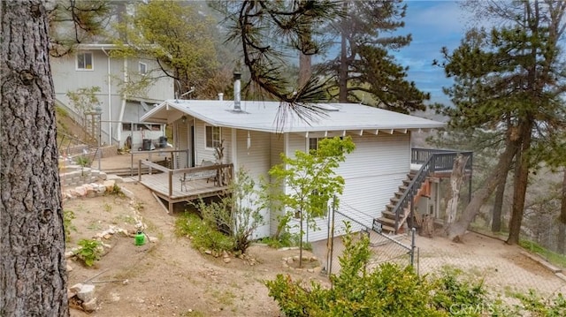 30919 Valley Oak Dr, Running Springs, CA 92382 - back of property featuring stairway and a wooden deck
