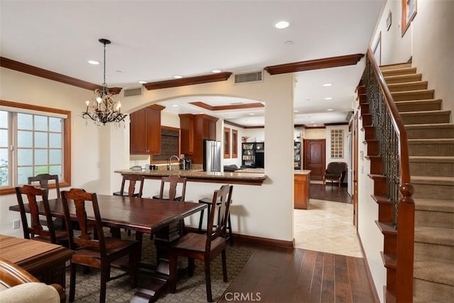 dining area featuring recessed lighting, wood finished floors, visible vents, stairs, and crown molding