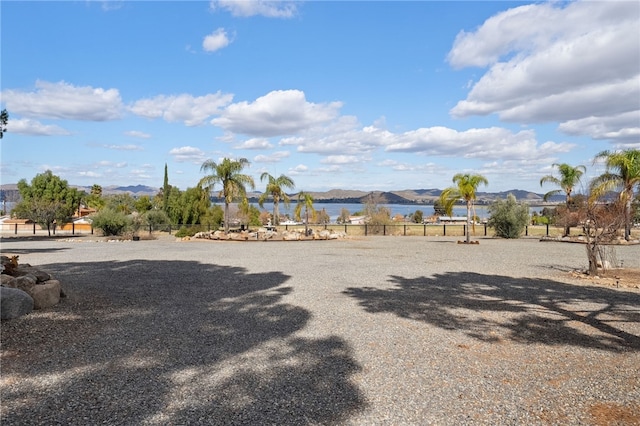 view of yard with a water view and fence