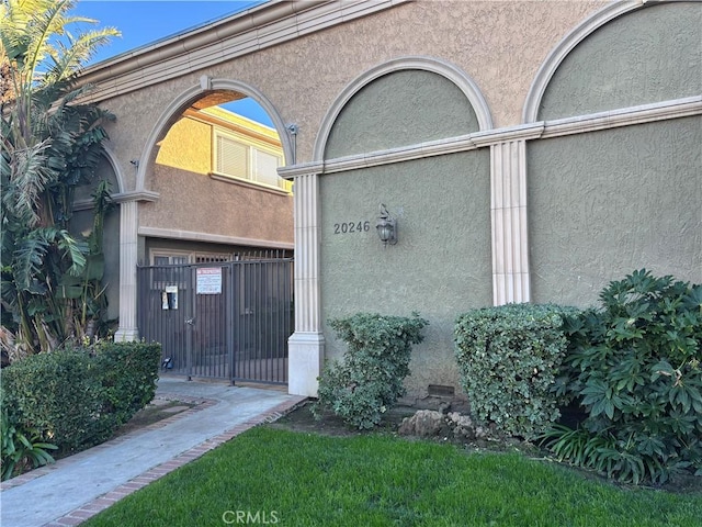 view of exterior entry featuring stucco siding