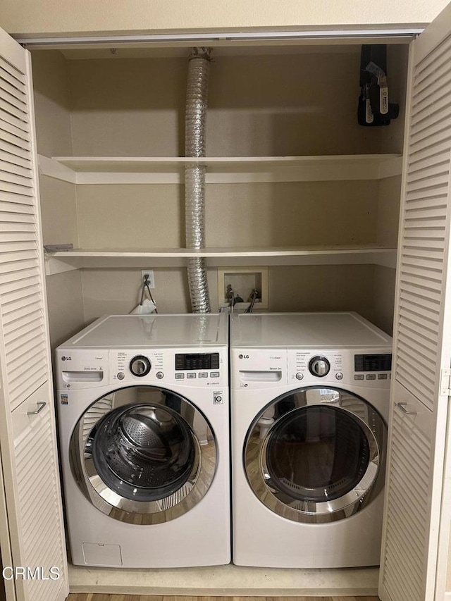 clothes washing area with laundry area and washer and clothes dryer