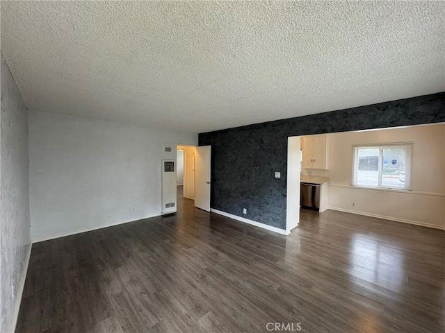 unfurnished living room featuring a textured ceiling, dark wood-type flooring, visible vents, and baseboards