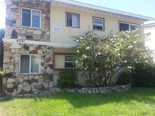 view of side of home with stone siding