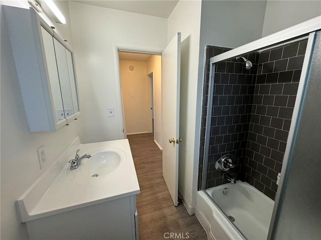 full bath with shower / washtub combination, wood finished floors, and vanity