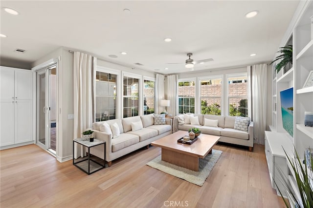 living area featuring a ceiling fan, light wood-type flooring, visible vents, and recessed lighting