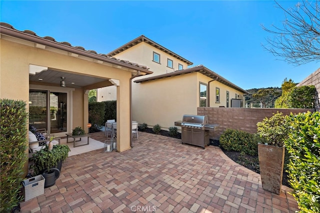 view of patio with a grill and fence