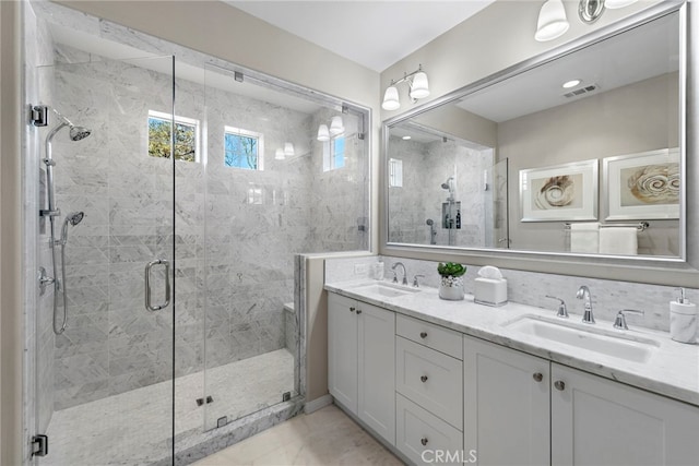 full bath with a stall shower, a sink, and visible vents