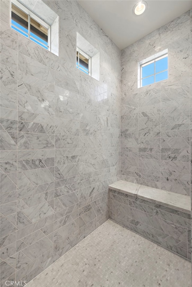 full bath with a tile shower