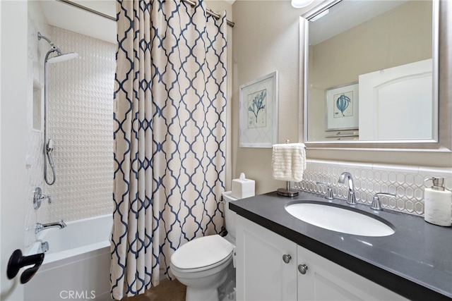 bathroom featuring toilet, shower / tub combo with curtain, and vanity