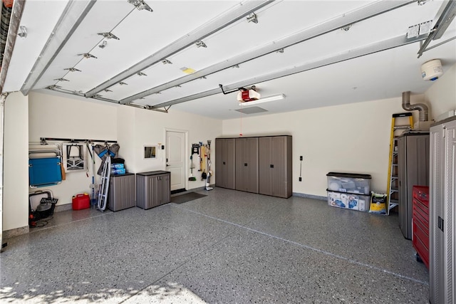 garage with baseboards and a garage door opener