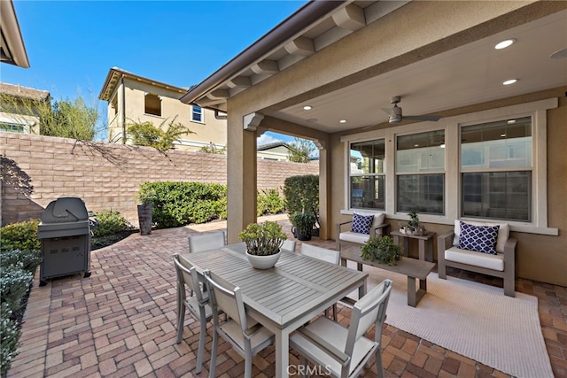 view of patio / terrace featuring ceiling fan, outdoor dining area, a grill, and fence