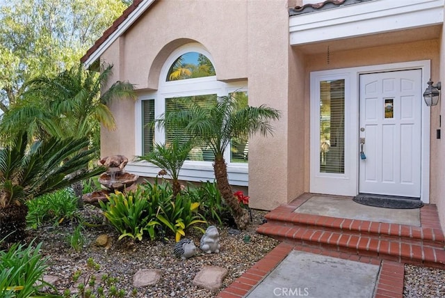 property entrance with stucco siding