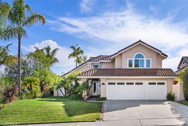 mediterranean / spanish house with driveway, a front lawn, a tile roof, and stucco siding