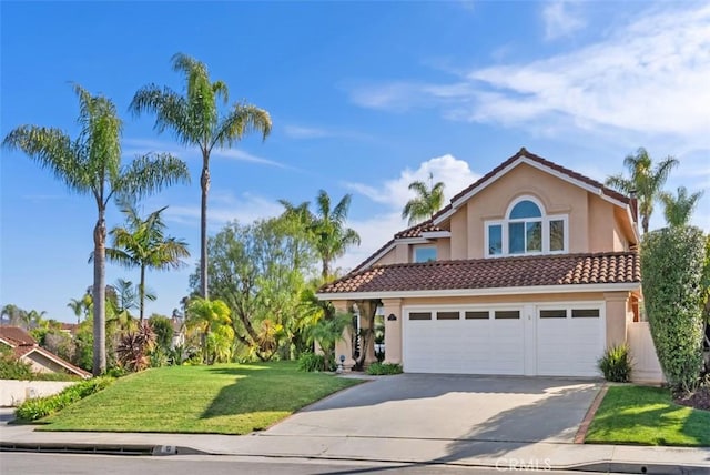 mediterranean / spanish-style home with driveway, a front lawn, a tiled roof, and stucco siding