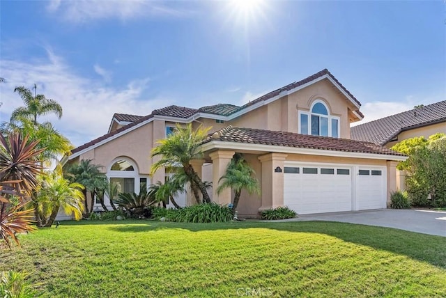 view of front facade featuring a tile roof, stucco siding, an attached garage, driveway, and a front lawn