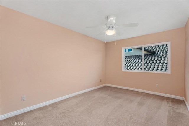 empty room with light carpet, ceiling fan, and baseboards