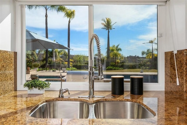 interior space featuring stone countertops and a sink