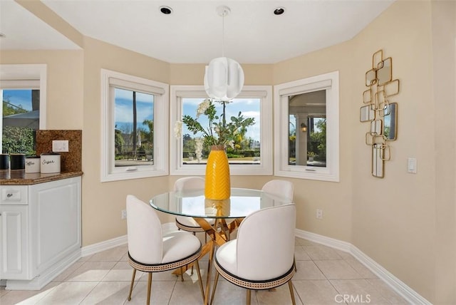 dining room with baseboards and light tile patterned floors