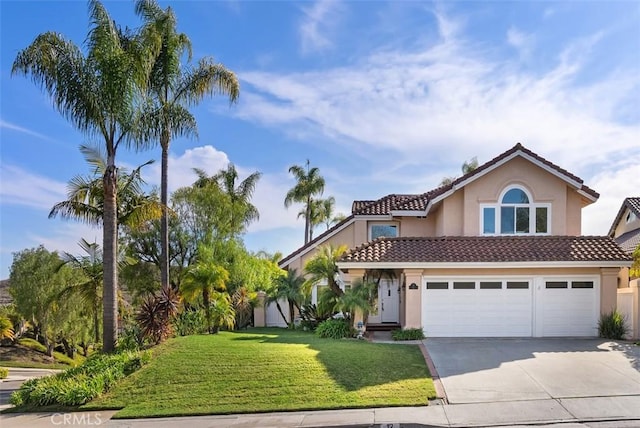 view of front of home with stucco siding, a tiled roof, concrete driveway, and a front yard