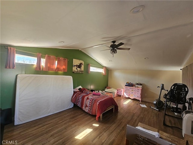 bedroom with a ceiling fan, vaulted ceiling, and wood finished floors