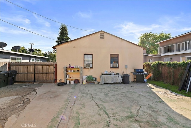 back of property featuring a patio, fence, and stucco siding