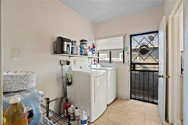 laundry area featuring laundry area, light tile patterned floors, and separate washer and dryer