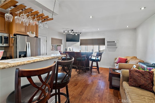 kitchen with open floor plan, appliances with stainless steel finishes, dark wood-style floors, and recessed lighting