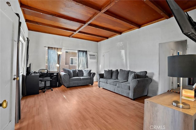 living area with wood finished floors and beam ceiling