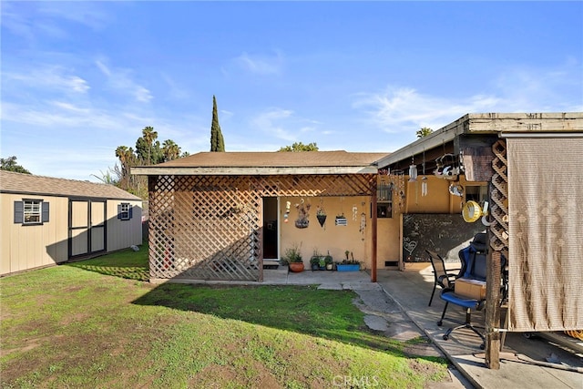 rear view of property featuring a patio and a yard