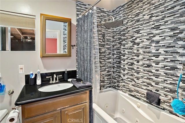 bathroom with a combined bath / shower with jetted tub and vanity