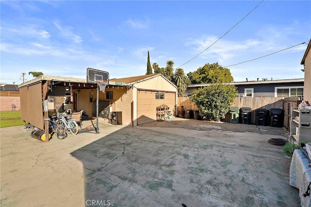 rear view of property featuring a patio area and fence