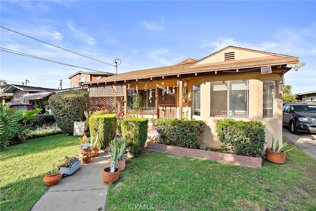 view of front of property with a front yard and stucco siding