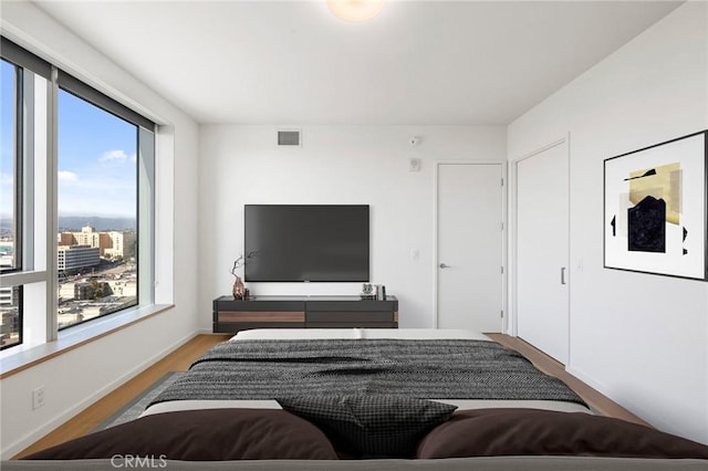 bedroom with wood finished floors and visible vents