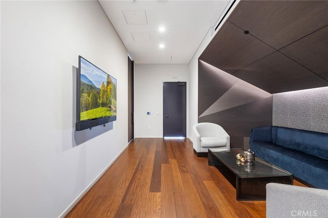 hall featuring wood finished floors and baseboards