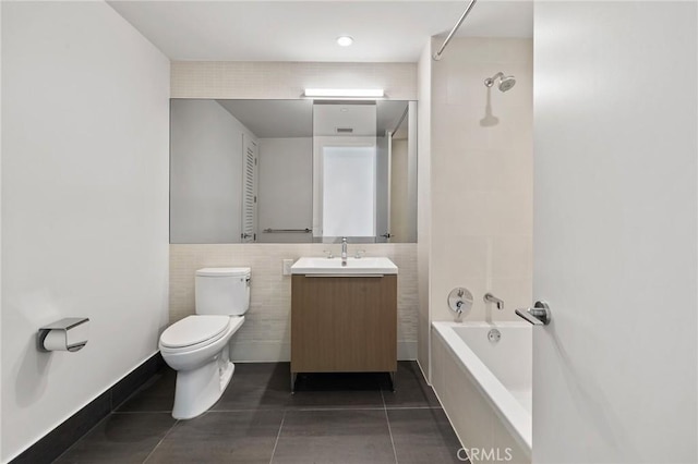 bathroom with tile patterned flooring, tile walls, toilet, and vanity