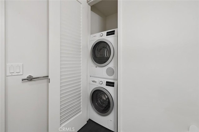 washroom with laundry area and stacked washer / dryer