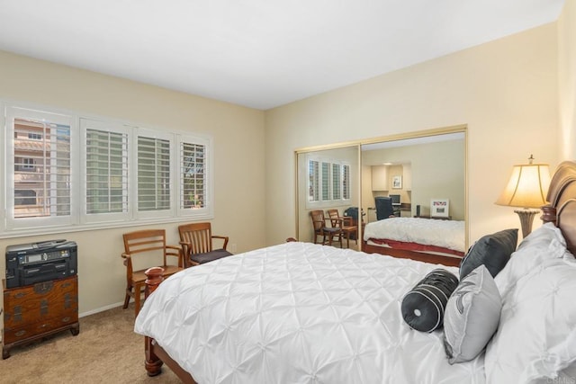 bedroom featuring a closet, carpet flooring, and baseboards