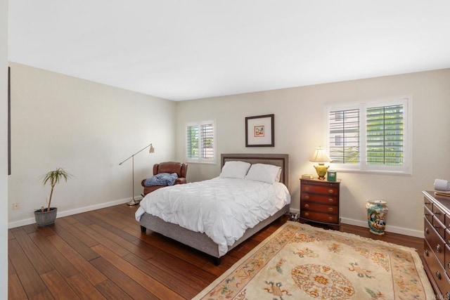 bedroom featuring baseboards and wood finished floors