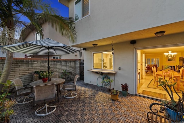 view of patio featuring outdoor dining area and fence