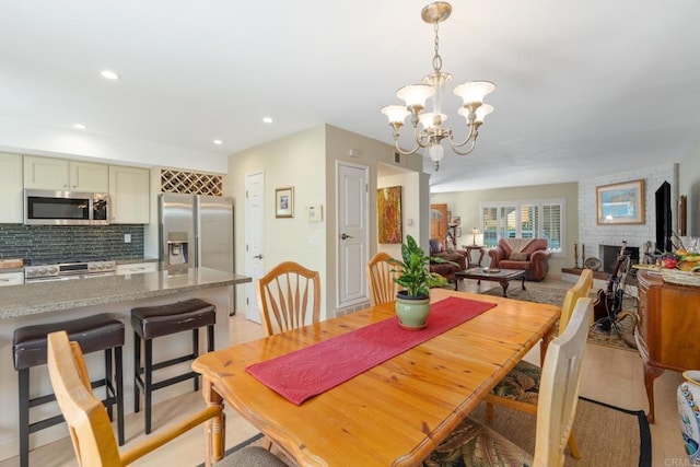 dining area with recessed lighting and a notable chandelier