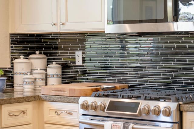 kitchen featuring white cabinetry, tasteful backsplash, and appliances with stainless steel finishes