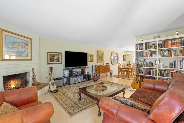 living area featuring an inviting chandelier, a fireplace, and wood finished floors